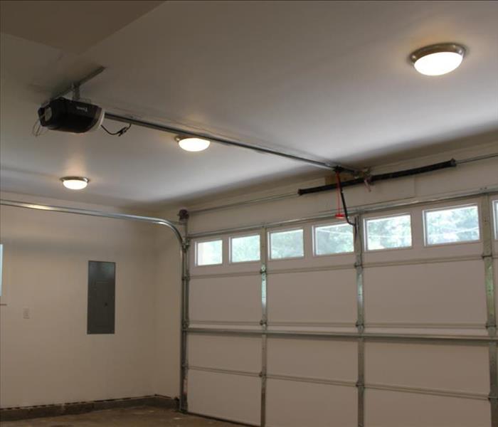 The garage has been restored thru cleaning with a new ceiling and garage door, white and bright