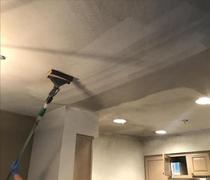 chem sponge cleaning a fire damaged ceiling
