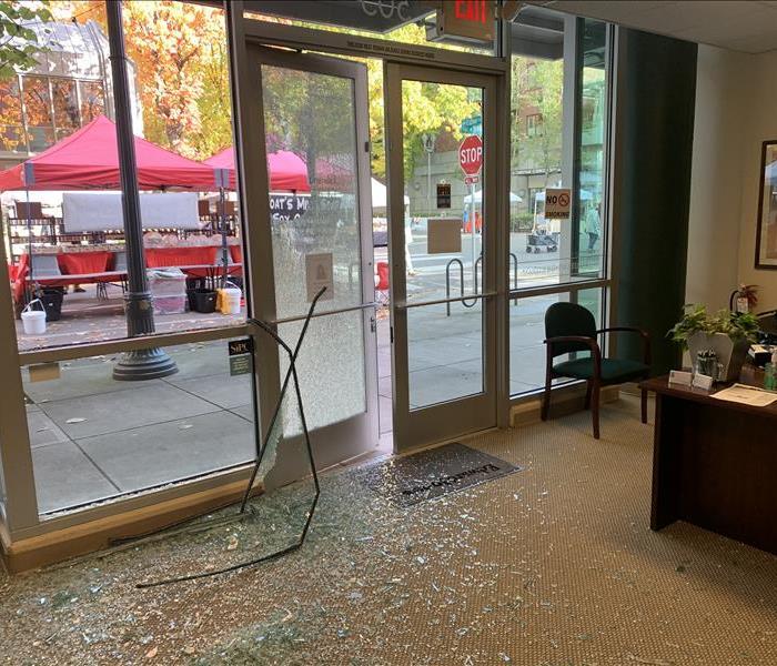 Vandalized business, broken glass windows